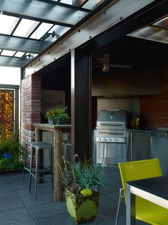 The tricked-out outdoor kitchen features a fleet of appliances from Kalamazoo Outdoor Gourmet. The company's K750HB Hybrid Fire Grill anchors the space and offers burners and a grill that can be fueled with wood or charcoal. An Energy Star–rated outdoor refrigerator and ample weatherproof storage ensures that all cooking and prep can take place on the deck—no running back and forth between inside and out.<br><br>"It's a wonderful kitchen," says Burgum. "One of the things I've appreciated the most is a full venting system over the grill. Being able to pull the heat and the smoke away when you're grilling is a key. The team anticipated the need for a refrigerator and the two burner stove. There isn't anything you can't cook up there—maybe just a cake!"<br><br>Photo by: David Bowman