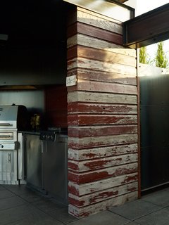 Burgum opted for locally sourced reclaimed wood from a demolished barn to build sections of the pergola covering the cookspace.<br><br>Photo by: David Bowman