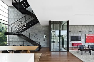 Modern High-Rise Town House in Tel Aviv - Photo 5 of 7 - The residents use either the black steel staircase or a glassed-in elevator by Wittur to get around the house.