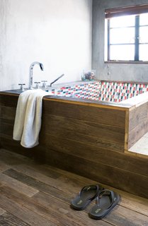 Modern Lilong House Renovation in Shanghai - Photo 10 of 11 - All of the floorboards in the house, as well as the wooden panels encasing the bathtub in the main bathroom, are made of antique door frames.
