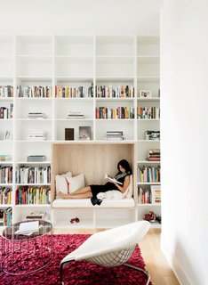 A Texas Couple Builds Their Cast-In-Place Concrete Dream Home - Photo 9 of 17 - Awaiting the birth of the couple’s son, Vivi relaxes in a built-in reading nook in the library.