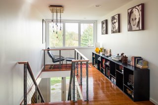 A quiet reading area sits on the second floor landing, where the home’s existing wood floors remain intact. Previously, that nook housed a closet, so views to the outdoors were obstructed. Michael felt it was important to have a continued connection to the yard when moving throughout the house, so he created a scheme to bring natural light inside and a view to the outside from the second floor.