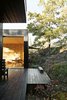 The house is divided into three sections connected by a series of outdoor galleries. “When I walk from one room to another, I have to go outdoors and feel the weather and nature—rain, cold, and sun,” says Sævik.
Instead of emphasizing the expansive panorama of oak, pine, and aspen trees, the house frames select views—a move inspired by Japanese design. Photo 4 of 430 Cabin modern home