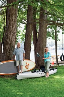Owners Dudley and Sandy Youman keep a flotilla of watercraft ready for entertaining their children and grandchildren. Interior designer Herb Schoening worked with the Youmans on the furnishings and finishes for their 480-square-foot cabin. Photo by: Kimberly Davis