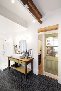 An Old Row House in Montreal Gets a Colorful Modern Upgrade - Photo 8 of 10 - The bathroom vanities were crafted from salvaged partition wall framing and original floorboards. Sustainability is a guiding principle of Fekete and de Loera's design, and materials were repurposed and upcycled wherever possible to honor the history and character of the 135-year-old row house.