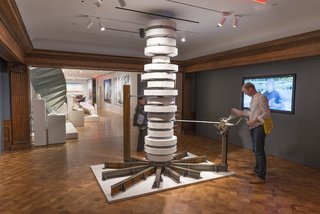 Entering the show, viewers are prompted to crank a large mechanical device for a takeaway exhibition brochure—a fitting representation of Heatherwick Studio's inventive, tinkering approach to design.