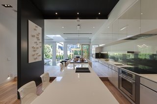 The view looking towards the South elevation in a linear manner starting from the kitchen countertop, dining area and heading towards the patio. All kitchen necessities perfectly lined with all surrounding details.