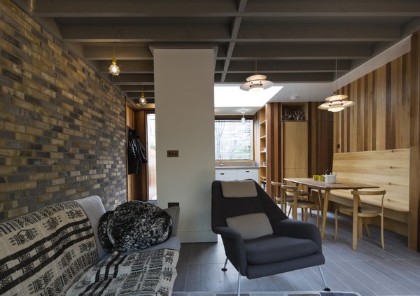 Handmade bricks from Petersen bricks are a prominent component in the house, stretching from the façade and walkway into the ground floor’s living space. Unifying the space was important to Thomson: the presence of Mosa ceramic tile throughout creates visual continuity. An Ernest Race chair sits next to a Hans Wegner sofa in the living room. Photo 2 of Islington Residence modern home