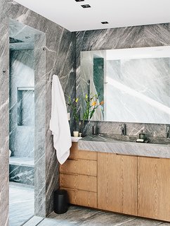 A Lush Retreat With a Sheltered Rooftop Pool in Mexico City - Photo 7 of 14 - The striking master bath is lined from floor to walls in silvery gray marble.