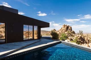 An unadorned black façade echoes the homeowners’ brief but compelling instructions to the architects to design a house like a shadow.