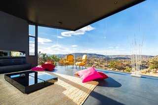 After sundown, the house itself seems to dematerialize into a dark starry expanse. For that reason, the homeowners have likened the living room to a campsite.