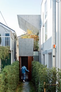 After purchasing a thin, L-shaped lot in Tokyo, Tamotsu Nakada asked architect and friend Koji Tsutsui to create an open-plan concrete home to fit the site.