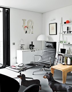 The room’s opposite side holds the companion Breuer nesting tables and an Eames Aluminum Group chair and ottoman.