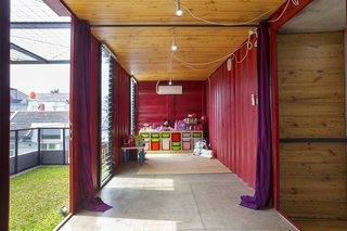 How to Stay Cool by Living in a Shipping Container - Photo 9 of 10 - A cherry red game room gives way to a second green space on the roof, which can be used as an extension of the indoor space.