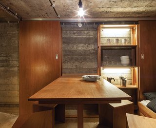 Custom-designed furniture outfits the interior of a bunker-turned-vacation retreat in the Netherlands.