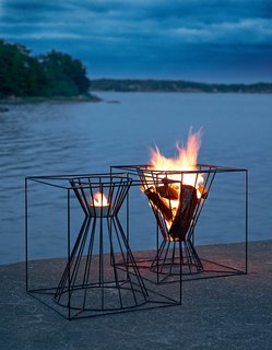 Gather Around These 7 Modern Fire Pit Designs - Photo 2 of 7 - The Boo Fire Basket from Skargaarden is made of black lacquered steel. Designed to fit several logs for an outdoor fire, the Boo can also be overturned to hold a candle or lantern.