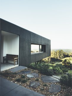 Modern House Captures Panoramic Views in Australia - Photo 2 of 5 - Located on a steep site with limited suitable building ground, the firm decided to cantilever the home over the hillside, which has the effect of helping the structure blend in with the landscape.