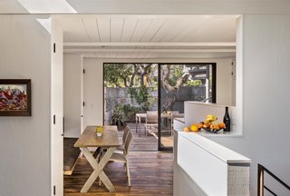 Guests now dine on a table from Coup d’Etat in the space where the residents used to enter the house. The dining room feels much larger than it actually is, thanks to a ten-foot-wide sliding glass door that opens onto a second, outdoor lounge.