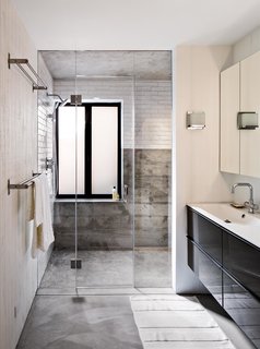 On the house’s lower level, Schicketanz’s guests have a bathroom complete with a steam shower to themselves. Anodized aluminum windows pop against white subway tile from Waterworks. The vanity is from Ikea and the fixtures from Hansgrohe.