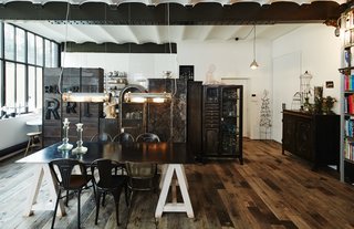 A row of vintage iron cabinets, mostly recovered from doctors’ and dentists’ offices, separate the kitchen from the dining area. The Gervasoni table was designed by close friend Paola Navone. Architect Dominique Perrault and designer Gaëlle Lauriot-Prévost are responsible for the the tubular pendants over the dining table, which resemble old subway lamps.
