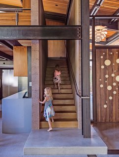 A Forest Sanctuary Designed to Support Autistic Triplets, Their Parents, and a Host of Caregivers - Photo 2 of 19 - The entrance is highlighted by a custom walnut door designed by the architect, Jack Hawkins. Cheryl Chenault designed the interiors.