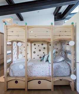 A Forest Sanctuary Designed to Support Autistic Triplets, Their Parents, and a Host of Caregivers - Photo 13 of 19 - A sloping ceiling allows light into one of the children’s bedrooms. The bed is from CedarWorks.