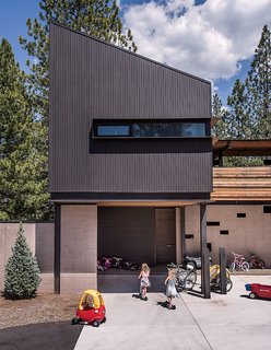 A Forest Sanctuary Designed to Support Autistic Triplets, Their Parents, and a Host of Caregivers - Photo 14 of 19 - The guesthouse hovers above the motor court. "The main area was broken up into four zones: the kids wing, the guest suite, the master suite, and the living-dining room and kitchen, which is a transition area, where public meets private," says Hawkins.