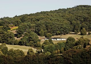 Richly Furnished Home Frames Striking Landscape Views - Photo 4 of 10 - Architect Kerstin Thompson designed the low-slung structure to follow the sloping site. A steel roof and Thermomass precast concrete panels protect the house in the fire-prone bush.
