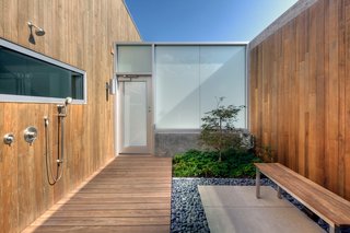 The outdoor shower situated off of the master bedroom is enclosed to offer privacy and features a courtyard garden. Michael Arp of Lanoha Nurseries designed the house's landscaping.
