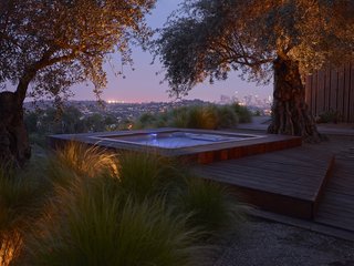 10 Modern Hot Tubs - Photo 3 of 10 - Three olive trees currently anchor the hot tub and deck area. The architects explain that transplanting them with a crane essentially positioned on a cliff face was one of the biggest challenges of the project.