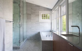 Interior walls were repainted and flooring was repaired, but the master bathroom received the most attention in the existing house. The renovation included marble mosaic floor tiles, fixtures by Blu Bathworks, and Silestone countertops.