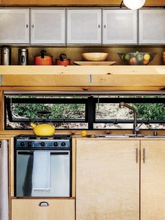 Container Store finds, like galvanized-steel shelving in the kitchen, maximize storage.