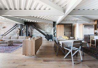 25 Homes With Exposed Beams: Rustic to Modern - Photo 10 of 25 - In the new 2,770-square-foot apartment, original I-beams brace the structure at dramatic angles and collide overhead, and the raw concrete is tempered by blackened steel, white-oak flooring, and bush-hammered Carrara marble—all selected by Willis.