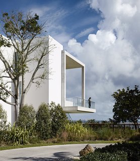 The Acrobatic Wonders of Concrete - Photo 8 of 10 - Jutting out over the landscape below, the cantilevered deck at the home of filmmaker-turned-designer Alejandro Landes looks out at Biscayne Bay in Miami's Coconut Grove neighborhood. The slim proportions of the porch seem to elude gravity, and the subtle texture of the concrete provides a contrast to the smooth surface of the rest of the house.