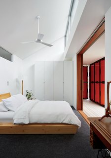 An Off-the-Grid Prefab that Combines Open Plan Living with Rugged Durability - Photo 10 of 10 - A wardrobe from IKEA and a bed by Rye Dunsmuir outfit one of two bedrooms.
