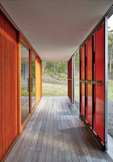 An Off-the-Grid Prefab that Combines Open Plan Living with Rugged Durability - Photo 8 of 10 - Both sets of panels slide open for maximum views and solar gain; in inclement weather, they shutter completely, while clerestory windows bathe the space in light.