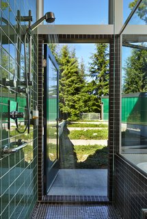 "I wanted the bathtub and shower to be at the foot of the terrace, so one could look out and feel the connection to the site," Coleman said. "French roast," an unglazed porcelain tile by American Olean, covers the shower.