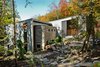 “The site was beautiful as it is,” architect Eric Tremblay said, and he wanted to build a home that had the least impact on the terrain as possible. The lake can be seen on either side of the house, and natural materials—like the Eramosa limestone coating on the exterior—were a priority during construction. Photo of Chalet Lac Gate modern home