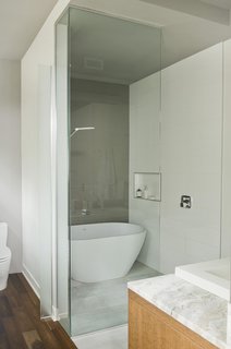 10 Ideas For Designing With a Modern Bathtub - Photo 2 of 10 - An Emily quartz bathtub by Caml-Tomlin is surrounded by Ceragres’ fade and frammenti tile.