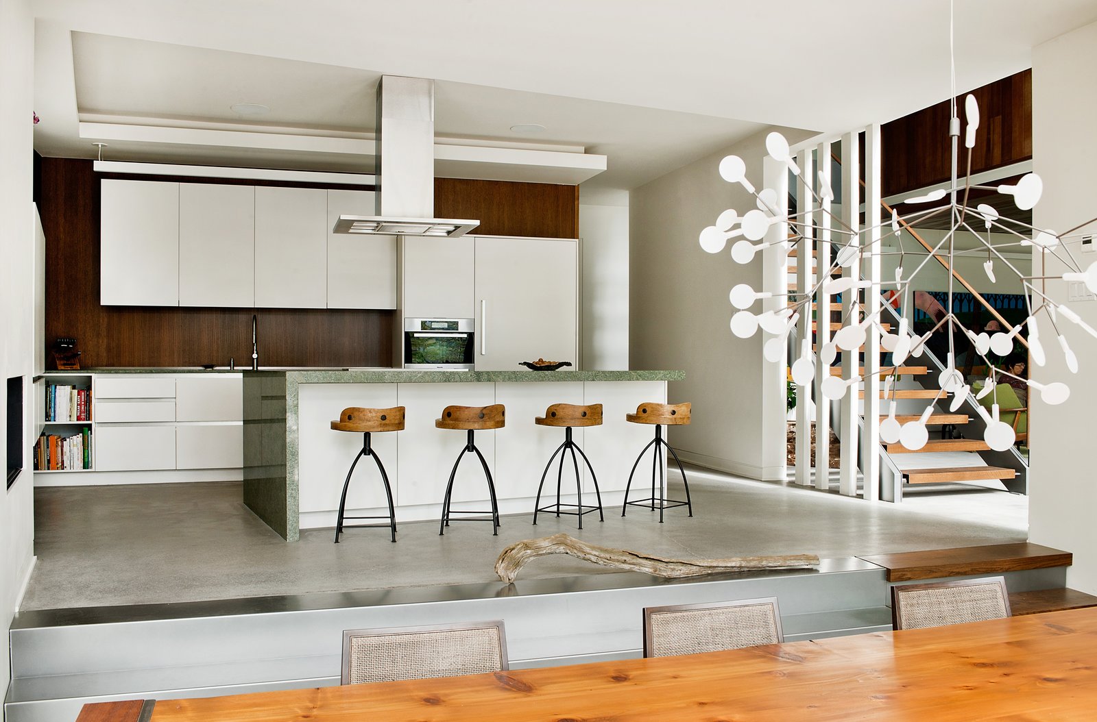 “Riftcut oak panels are used in woodworking and on some kitchen walls,” said Tremblay. The design of the cabinets is by Tremblay’s firm, Boom Town, with fabrication by Atelier Boisteck. Stools by Arteriors are lined in front of a granite countertop from Costa Esmeralda.