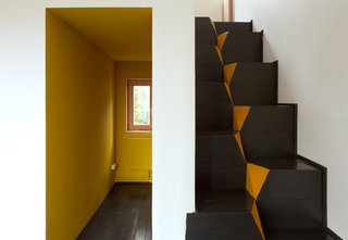 A Compact Home in Moscow Built on the Lowest Possible Budget - Photo 3 of 9 - A corridor-like entrance invites residents into the home. The architects chose to use goose-step stairs because of their safety and efficiency in compact spaces. "This staircase is also the easiest in terms of construction," Kolchin says. "It is nearly impossible to make any mistake while building it."
