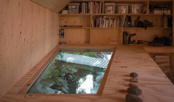 A ‘light soffit’ offers a dynamic view of the stream below, providing both visual and audio stimulation. Throughout the year, the studio is filled with the sound of water, from the ocean waves to the rain and drizzle, to the flowing stream below. The artist, who has a longstanding connection to the site, focuses on “art which leaves marks at once permanent and delicate,” much like the structure itself. Photo 6 of Midden Studio modern home