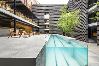 A pool is still the focal point of the courtyard, but its modernized, streamlined design makes a dramatic statement.