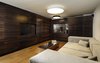 Downstairs in the basement, an entertainment room is inspired by the idea of an English pub. Dark, rich wood tones are favored in this popular meeting place for friends. The space was designed to be soundproof in order to maintain privacy from the two older children's bedrooms, also on the basement level. A wine bar, flat screen TV, and stainless steel table complete the space. Photo 7 of Rishon Le Zion 3 modern home
