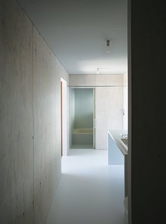 Japanese Home Among the Trees Uses Bookshelves and Glass for Walls - Photo 4 of 8 - Most of the house is oriented toward the glass curtain wall overlooking the town of Odawara, save for private areas like the shared bathroom.
