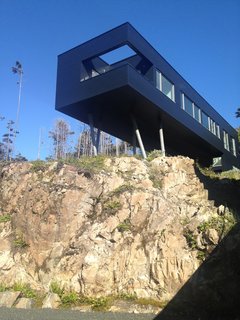 This enormous modular home by Tony Robins of Vancouver-based AA Robins Architect was built in partnership with a prefabrication factory. Two-foot-wide steel beams were enlisted to support the 20-module home. The primary building’s wings frame Pacific Ocean views and wrap a private courtyard with an infinity-edge pool. Five bedrooms disperse in a U-shape along a corridor that's punctuated by low, horizontal windows facing the courtyard. 