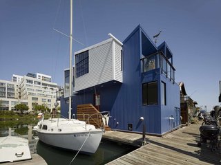 Marked by its sawtooth roof and shipping container–like facade, the home is moored to the dock alongside boats. Since there’s no way to paint a floating house, Nebolon chose to clad the exterior in 24-gauge metal siding coated with a fluorocarbon finish that will resist fading and chalking for 40 years. "It’s a very durable paint system that doesn’t require periodic painting," he explains. "An annual hose-down will work just fine."