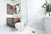Modern home with bath room, porcelain tile floor, pendant lighting, open shower, engineered quartz counter, two piece toilet, and marble wall. “What could I have that would feel luxurious, would make me feel really great?” muses one of the homeowners. “My husband and I travel a lot in Europe, and we always loved the marble showers. So we put a marble shower up against the window.” The sink and countertop are from Batimat, while the wall-hung vanity is another custom piece by Gepetto. Photo 5 of Brick House
