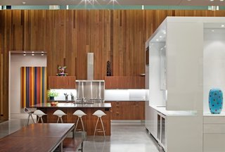 This house features 16-foot-high ceilings and is heated and cooled primarily from geothermal ground loops, with radiant lines inside the concrete floors. It features low-VOC paints and interior finishes, locally sourced materials, blown in soy-based spray foam exterior insulation, skylights and solatubes for natural daylighting, FSC-certified lumber, and LED light fixtures. The exterior is clad in zinc and cedar, which extends into the interior.