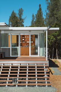A longtime fan of the Case Study houses of the late ‘50s and early ‘60s, Terry Ohm was attracted to the iT House, by Taalman Koch Architecture, for the design’s "transparency and minimalism." His customized, smaller-scale version stands on a rural plot of land in Lake County, California. Ohm sits on his broad front steps often and appreciates their strong visual impact: "The house is so little, you’ve gotta go for grand wherever you can get it!"